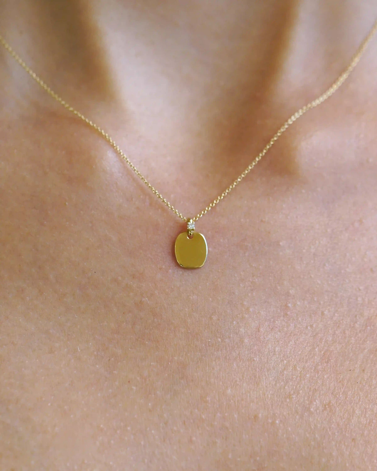 Yellow gold necklace with rectangular pendant and diamond detail